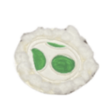 The classic Yoshi egg with one full green spot plus 2 cut off by the edge of the egg on top of a disk covered in white cotton pieces.